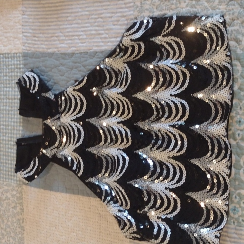 A black white and silver halter top with back zipper and cups, midrift